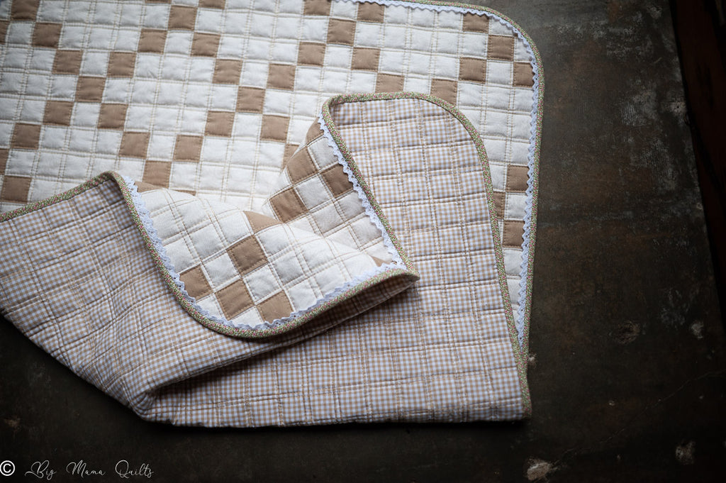 Folded quilt with checkered pattern on a dark surface